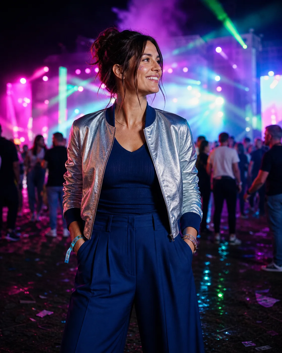 Adult woman in a silver jacket at a colorful outdoor music festival