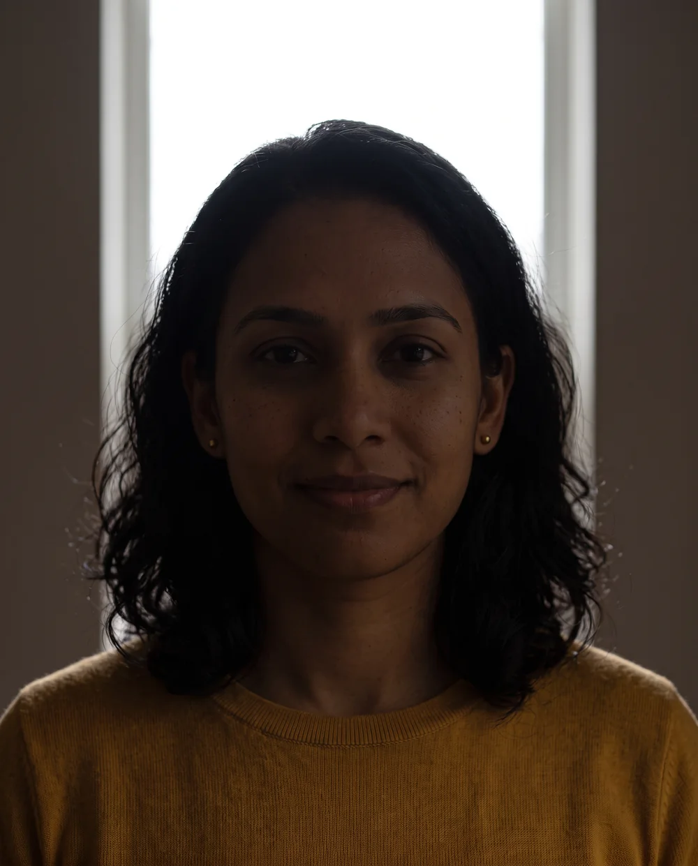 Synthetic portrait with a bright background and a face in shadow.